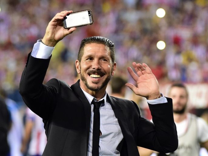 Atletico Madrid's Argentinian coach Diego Simeone celebrates after winning the Super Cup at the end of the Spanish Supercopa second-leg football match Atletico de Madrid vs Real Madrid CF at the Vicente Calderon Stadium in Madrid on August 22, 2014. Atletico de Madrid won 1-0. AFP PHOTO/ GERARD JULIEN