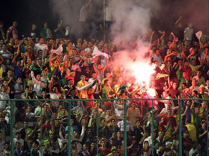 epa02327481 Algerian fans of JS Kabylie celebrate after scoring against Egypt Ismaily during their first round soccer match of the African Champions League (CAF) in Tizi-Ouzou, some 120 km east of the capital Algiers, Algeria, late 10 September 2010. EPA/MOHAMED MESSARA