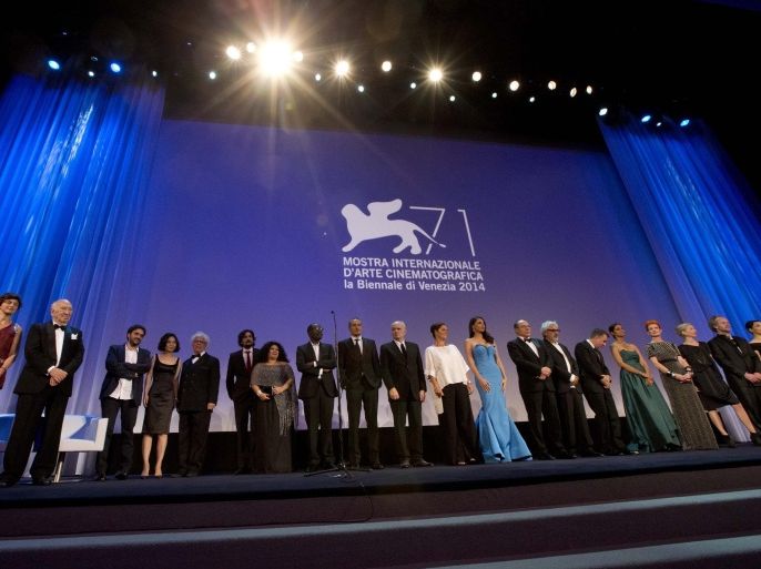 Members of the juries of different sections of the 71st edition of the Venice Film Festival stand on the stage during the opening ceremony of the Festival in Venice, Italy, Wednesday, Aug. 27, 2014. (AP Photo/Andrew Medichini)