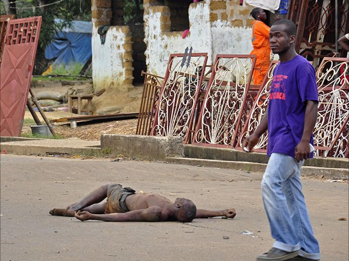 The lifeless body of a man lays unattended in the street as locals suspect him of dying from the deadly Ebola virus, as government warns the public not to leave Ebola victims in the streets in the city of Monrovia, Liberia, Tuesday, Aug. 5, 2014. A second American aid worker infected with Ebola arrived Tuesday in Atlanta, where doctors will closely monitor the effect of an experimental drug she agreed to take even though its safety was never tested on humans. Nancy Writebol arrived from Monrovia, Liberia, in a chartered plane at Dobbins Air Reserve Base and will join Dr. Kent Brantly in the isolation unit at Emory University Hospital, just downhill from the U.S. Centers for Disease Control and Prevention. (AP Photo/Abbas Dulleh