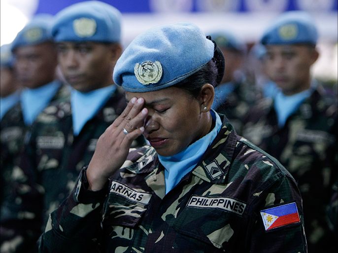 epa03321265 A Filipino female soldier as part of the United Nations (UN) Peace Keeping Force to Liberia gestures during send off ceremony inside a military base in Taguig city, south of Manila, Philippines, 28 July 2012. The Philippine contingent is tasked to assist in the maintenace of law and order in Liberia following a ceasefire that ended the Second Liberian Civil War. EPA