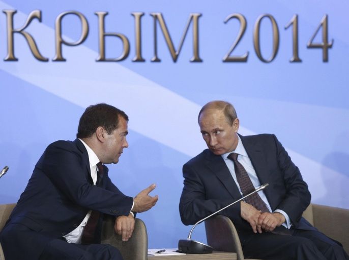 Russia's President Vladimir Putin (R) and Prime Minister Dmitry Medvedev attend a meeting with members of the Russian Parliament and other politicians and officials in Yalta, Crimea, August 14, 2014. Putin said on Thursday Russia would stand up for itself but not at the cost of confrontation with the outside world, a conciliatory note after months of tough rhetoric over the crisis in Ukraine. REUTERS/Dmitry Astakhov/RIA Novosti/Pool (UKRAINE - Tags: POLITICS CONFLICT CIVIL UNREST) ATTENTION EDITORS - THIS IMAGE HAS BEEN SUPPLIED BY A THIRD PARTY. IT IS DISTRIBUTED, EXACTLY AS RECEIVED BY REUTERS, AS A SERVICE TO CLIENTS