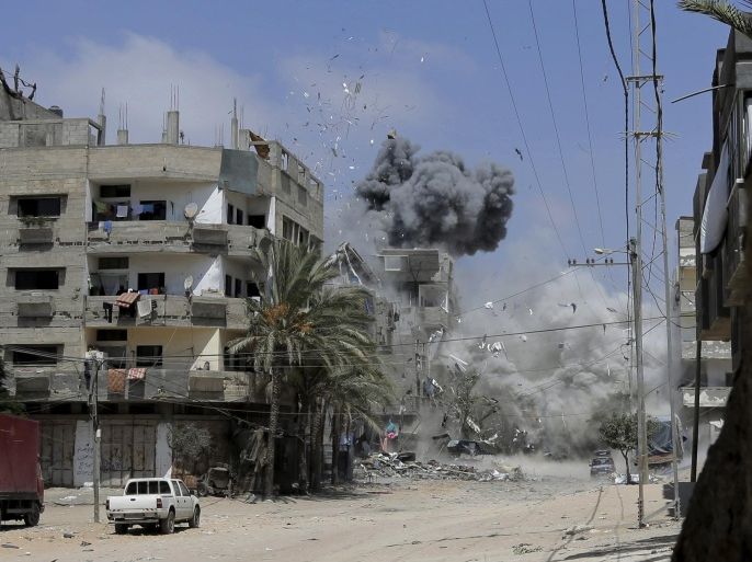Smoke and dust rise after an Israeli strike on a three-story building belonging to the Abdul Hadi family in Gaza City in the northern Gaza Strip, Sunday, Aug. 24, 2014. (AP Photo/Adel Hana)