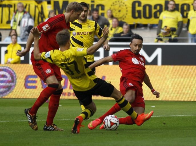 Bayer Leverkusen's Karim Bellerabi (R) scores a goal against Borussia Dortmund during the German first division Bundesliga soccer match in Dortmund August 23, 2014. REUTERS/Ina Fassbender (GERMANY - Tags: SPORT SOCCER) DFL RULES TO LIMIT THE ONLINE USAGE DURING MATCH TIME TO 15 PICTURES PER GAME. IMAGE SEQUENCES TO SIMULATE VIDEO IS NOT ALLOWED AT ANY TIME. FOR FURTHER QUERIES PLEASE CONTACT DFL DIRECTLY AT + 49 69 650050