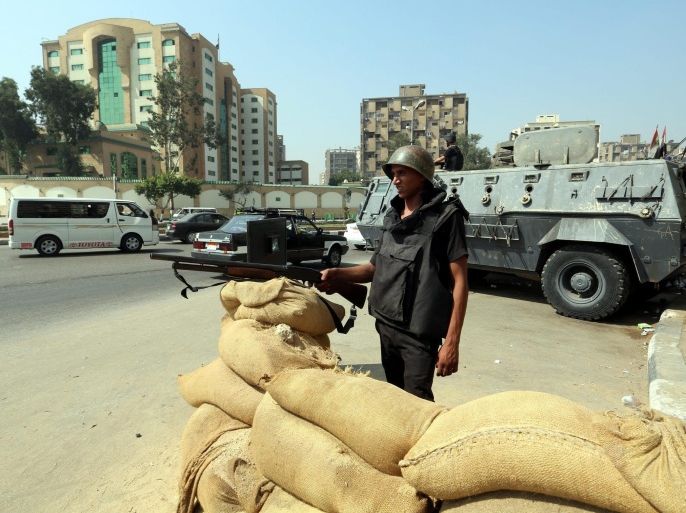 Egyptian soldiers stand guard in the Rabaa Adawiya Square, in the Nasr city neighborhood of Cairo, Egypt, 14 August 2014. Gunmen shot dead a police sergeant in Cairo on on 14 August 2014, as security forces were on heigtened alert for the first anniversary of the killing of hundreds of Islamist protesters.