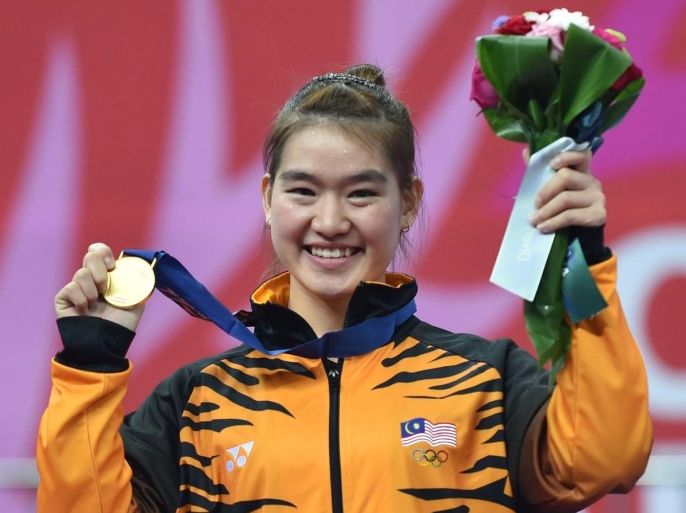 Malaysia's gold medalist Cheau Xuen Tai celebrates during the medal ceremony of the women's wushu nanquan final at the 2014 Asian Games in Incheon on September 20, 2014. AFP PHOTO / Bay ISMOYO