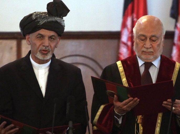 Afghan President Ashraf Ghani Ahmadzai, left, is sworn in by Chief Justice Abdul Salam Azimi, during his inauguration ceremony at the presidential palace in Kabul, Afghanistan, Monday, Sept. 29, 2014. Ghani Ahmadzai He replaces Hamid Karzai in the country's first democratic transfer of power since the 2001 U.S.-led invasion toppled the Taliban. (AP Photo/Rahmat Gul)