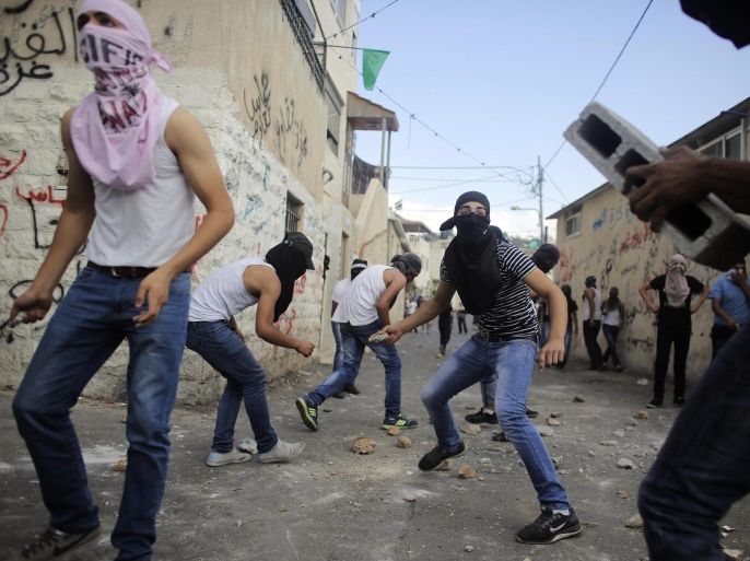 Palestinians hurl stones during clashes with Israeli police in the East Jerusalem neighbourhood of Wadi Joz September 7, 2014. Scores of Palestinians rioted in Israeli-occupied East Jerusalem on Sunday after news that a youth, Mohammed Sinokrot, had died of wounds suffered in a clash with Israeli police last week. There were no reports of serious injury in Sunday's unrest. Protesters in the neighbourhood of Wadi Joz close to the walled Old City, threw rocks, petrol bombs and flares at passing cars, and riot officers responded with rubber bullets during an afternoon of clashes that lasted hours. REUTERS/Ammar Awad (JERUSALEM - Tags: POLITICS CIVIL UNREST TPX IMAGES OF THE DAY)