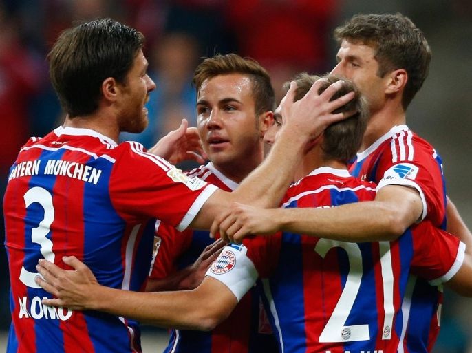 Bayern Munich's Xabi Alonso, Mario Goetze, Philipp Lahm and Thomas Mueller (L-R) celebrate after Goetze scored a goal against Paderborn during their German first division Bundesliga soccer match in Munich September 23, 2014. REUTERS/Michael Dalder (GERMANY - Tags: SPORT SOCCER) DFL RULES TO LIMIT THE ONLINE USAGE DURING MATCH TIME TO 15 PICTURES PER GAME. IMAGE SEQUENCES TO SIMULATE VIDEO IS NOT ALLOWED AT ANY TIME. FOR FURTHER QUERIES PLEASE CONTACT DFL DIRECTLY AT + 49 69 650050