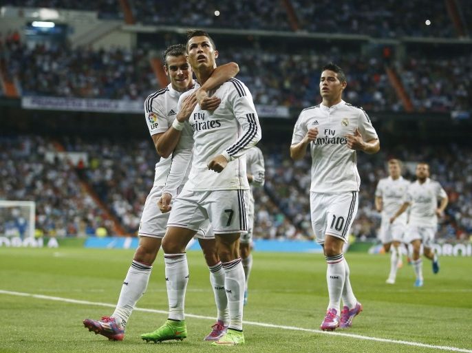 Real's Cristiano Ronaldo, second left, celebrates his goal with Real's Gareth Bale, left, during a Spanish La Liga soccer match between Real Madrid and Elche at the Santiago Bernabeu stadium in Madrid, Spain, Tuesday, Sept. 23, 2014. (AP Photo/Andres Kudacki)