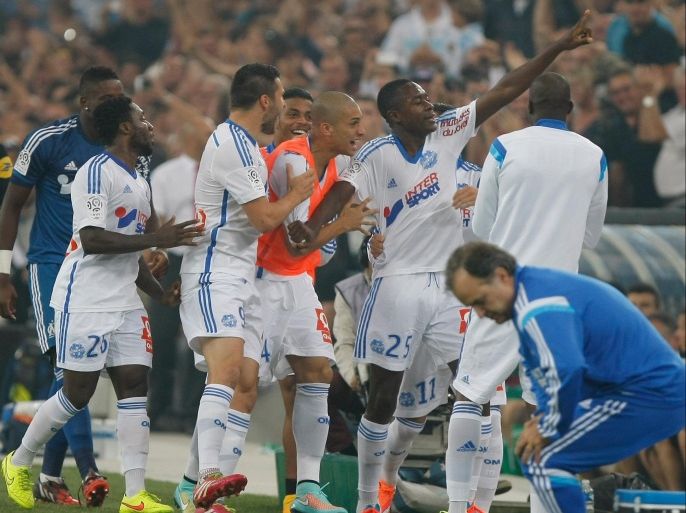 Marseille's French midfielder Giannelli Imbula, second right, celebrates with his teammates after scoring against Saint-Etienne, during their League One soccer match, at the Velodrome Stadium, in Marseille, southern France, Sunday, Sept. 28, 2014. (AP Photo/Claude Paris)