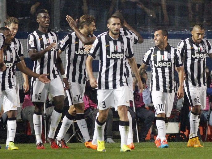 Juventus players celebrate after teammate Carlos Tevez, second from right, scored during a Serie A soccer match against Atalanta in Bergamo, Italy, Saturday, Sept. 27, 2014. (AP Photo/Felice Calabro')