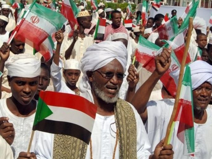Sudanese men wave Iranian and Sudanese flags celebrating Iranian President Mahmoud Ahmadinejad's visit with President Omar al-Bashir in Khartoum, Sudan, Monday, Sept. 26, 2011. Ahmadinejad is on a a two-day visit to Sudan.