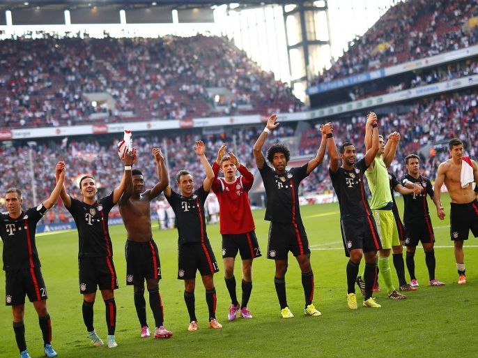 Bayern Munich's players celebrate after their German first division Bundesliga soccer match against FC Cologne in Cologne, September 27, 2014. Bayern won the match 2-0. REUTERS/Kai Pfaffenbach (GERMANY - Tags: SPORT SOCCER) DFL RULES TO LIMIT THE ONLINE USAGE DURING MATCH TIME TO 15 PICTURES PER GAME. IMAGE SEQUENCES TO SIMULATE VIDEO IS NOT ALLOWED AT ANY TIME. FOR FURTHER QUERIES PLEASE CONTACT DFL DIRECTLY AT + 49 69 650050