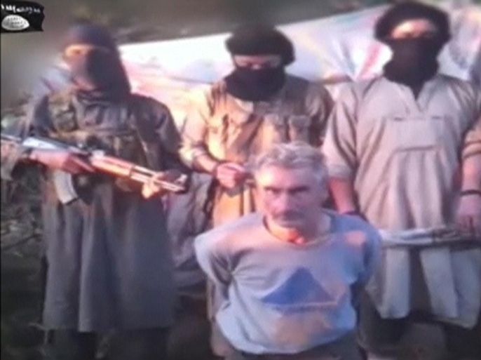Kidnapped Frenchman Herve Gourdel (C) kneels in front of masked militants gunmen, in this still image taken from video which was published on the Internet on September 24, 2014. Algerian militants have beheaded French tourist Herve Gourdel, who was kidnapped by gunmen on Sunday in what the group said was a response to France's action against Islamic State militants in Iraq. In the video released by his captors, Gourdel, a 55-year-old from Nice, is seen kneeling with his arms tied behind his back before four masked militants who read out a statement in Arabic criticising France's intervention. They then pushed him on his side and held him down. The video does not show the beheading, but a militant later holds the head up to the camera. MANDATORY CREDIT REUTERS/SITE Intel Group via Reuters TV (CIVIL UNREST CRIME LAW POLITICS TPX IMAGES OF THE DAY) ATTENTION EDITORS - THIS PICTURE WAS PROVIDED BY A THIRD PARTY. REUTERS IS UNABLE TO INDEPENDENTLY VERIFY THE AUTHENTICITY, CONTENT, LOCATION OR DATE OF THIS IMAGE. FOR EDITORIAL USE ONLY. NOT FOR SALE FOR MARKETING OR ADVERTISING CAMPAIGNS. NO SALES. NO ARCHIVES. THIS PICTURE IS DISTRIBUTED EXACTLY AS RECEIVED BY REUTERS, AS A SERVICE TO CLIENTS. MANDATORY CREDIT