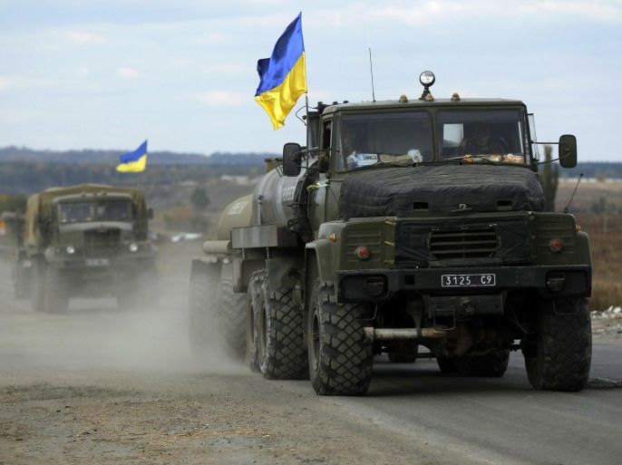 A Ukrainian military convoy moves on the road near the eastern Ukrainian town of Slaviansk, October 5, 2014. Ukraine's military accused Russian-backed separatists of again violating a month-old ceasefire on Sunday, saying their forces came under attack in several parts of the east including the airport at the big city of Donetsk. REUTERS/David Mdzinarishvili (UKRAINE - Tags: POLITICS CIVIL UNREST MILITARY)