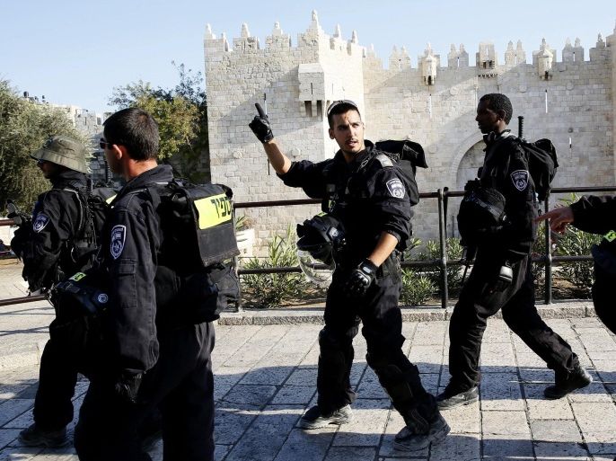 Israeli policemen patrol the Old City in Jerusalem on October 26, 2014. Tension soared in east Jerusalem as stone-throwing Palestinians and police clashed ahead of a funeral for a Palestinian man who ploughed his car into a crowd of Israelis, killing a baby. AFP PHOTO/ GALI TIBBON