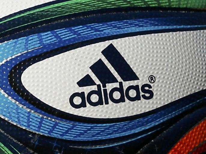 File photo of an official 2014 World Cup football printed with an Adidas logo, in Sion May 31, 2014. Shares in German sportswear firm Adidas AG jumped October 20, 2014, after the Wall Street Journal reported that an investor group that includes Jynwel Capital and funds affiliated with the Abu Dhabi government planned a $2.2 billion bid to buy Reebok. REUTERS/Denis Balibouse/Files (SWITZERLAND - Tags: BUSINESS SPORT BUSINESS LOGO)