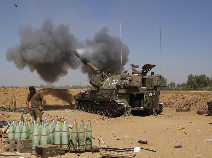An Israeli mobile artillery unit fires towards the southern Gaza in this August 1, 2014 file photo. The July-August war in Gaza drew international condemnation for a number of reasons, but one episode proved more deadly than any other: an Israeli air and artillery bombardment on Aug. 1 that killed 150 people in a matter of hours.The events unfolded just as a three-day ceasefire was supposed to come into force. Hamas militants emerged from a tunnel inside Gaza and ambushed three Israeli soldiers, killing two of them and seizing the third.To rescue the soldier - dead or alive - and ensure Hamas could not use him as a hostage, the Israeli army invoked what is known as the "Hannibal directive", an order compelling units to do everything they can to recover an abducted comrade.What ensued was a furious assault on a confined area on the eastern edge of Rafah, the largest city in southern Gaza. To match Insight: MIDEAST-GAZA/WARCRIME REUTERS/Baz Ratner/Files (ISRAEL - Tags: POLITICS CIVIL UNREST CONFLICT)