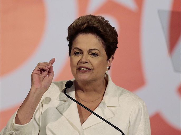 Brazil's President and Workers' Party (PT) presidential candidate Dilma Rousseff gestures during a news conference after voting in the first round of election in Brasilia, October 5, 2014. Rousseff placed first in Sunday's election but did not get enough votes to avoid a runoff and will face pro-business rival Aecio Neves, who made a dramatic late surge to finish a strong second. REUTERS/Ueslei Marcelino (BRAZIL - Tags: POLITICS ELECTIONS)