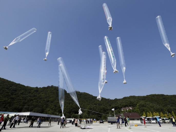 North Koran defectors release balloons carrying leaflets condemning North Korean leader Kim Jong Un and his government's policies, in Paju, near the border with North Korea, South Korea, Friday, Oct. 10, 2014. The activists launched balloons carrying about 200,000 anti-North Korea leaflets over the border on Friday when North Korea marks the 69th anniversary of the founding of the ruling Workers' Party. (AP Photo/Ahn Young-joon)