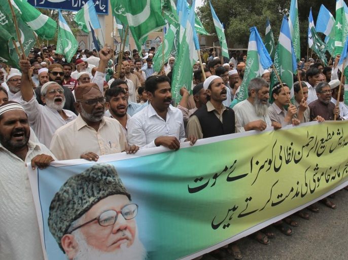 Supporters of Pakistan's religious party Jamaat-e-Islami rally to condemn the court verdict against Bangladeshi religious leader, Friday, Oct. 31, 2014 in Karachi, Pakistan. A special Bangladeshi tribunal sentenced Motiur Rahman Nizami, a leader of the Jamaat-e-Islami, to death on Wednesday for atrocities and multiple killings during the nation's independence war against Pakistan in 1971. Banner reads, "We condemned the criminal silence of Pakistani government over the death sentence." (AP Photo/Fareed Khan)