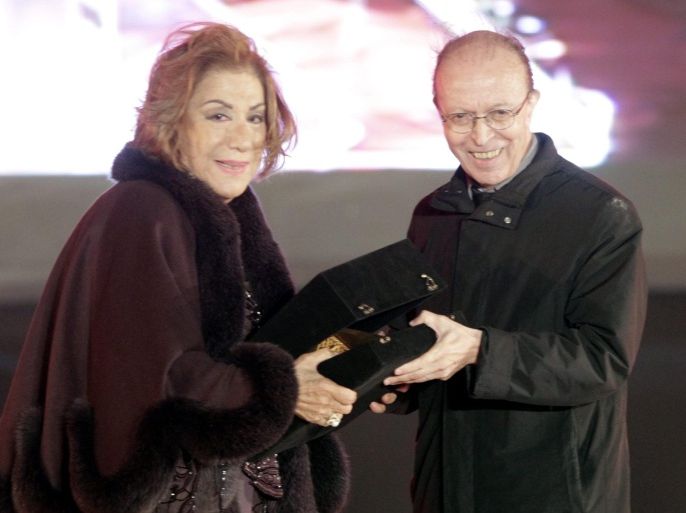 Moroccan Director Nour Eddine Saïl receives an honorary award from Egyptian actress Samiha Ayoub (L) during the opening ceremony of the 36th Cairo International Film Festival (CIFF) in Cairo, Egypt, 10 November 2014. The CIFF takes place from 09 to 18 November.