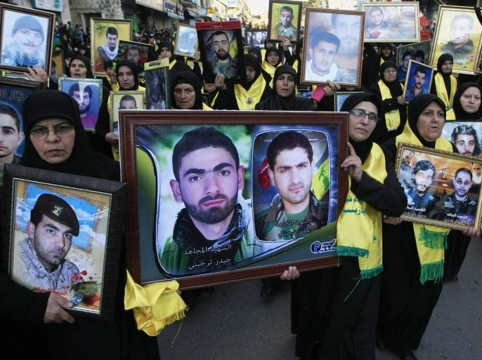 Lebanese Hezbollah supporters carry pictures of Hezbollah fighters who were killed in battle in Syria and against Israel, during a rally to mark the 13th day of Ashoura, in the southern market town of Nabatiyeh, Lebanon, Friday, Nov. 7, 2014. Shiites mark Ashoura, the tenth day of the Islamic month of Muharam, to commemorate the Battle of Karbala in the 7th century when Imam Hussein, a grandson of Prophet Muhammad, was killed in present-day Iraq. (AP Photo/Mohammed Zaatari)