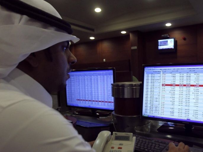 A broker monitors stock prices on a screen at the Saudi Investment Bank in Riyadh in this file photo taken September 5, 2013. Saudi Arabia plans to open its stock market, the Arab world's biggest, to direct investment by foreign financial institutions in the first half of next year, the market regulator said on Tuesday. REUTERS/Faisal Al Nasser/Files (SAUDI ARABIA - Tags: BUSINESS)