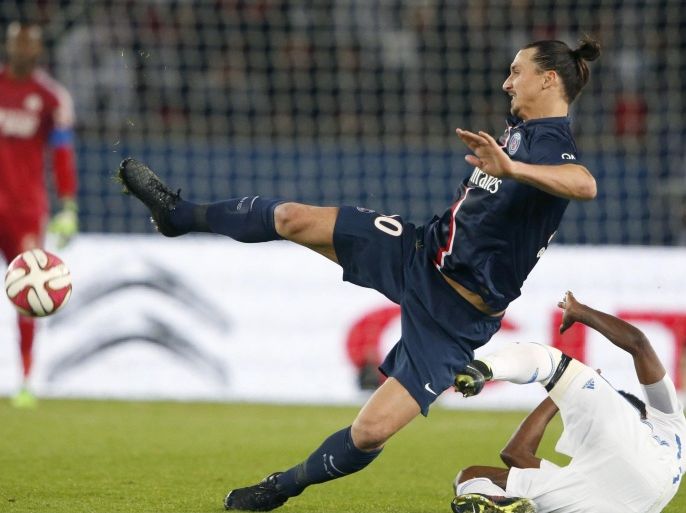 Paris St Germain's Zlatan Ibrahimovic (L) challenges Olympique Marseille's Nicolas Nkoulou during their French Ligue 1 soccer match at the Parc des Princes stadium in Paris November 9, 2014. REUTERS/Charles Platiau (FRANCE - Tags: SPORT SOCCER TPX IMAGES OF THE DAY)