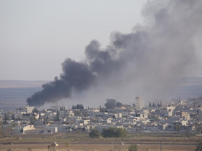 SANLIURFA, TURKEY - NOVEMBER 09: A photograph taken from Suruc district of Sanliurfa, Turkey, shows smoke rising from the Syrian border town of Kobani (Ayn al-Arab) following the US-led coalition airstrikes against the Islamic State of Iraq and the Levant (ISIL) targets on November 09, 2014.