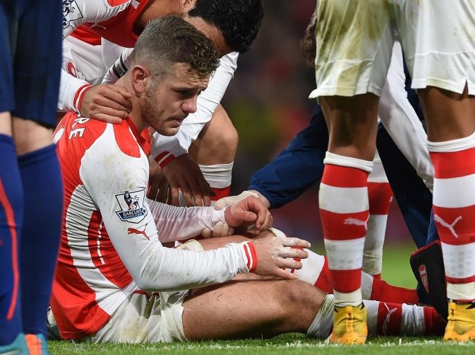 Arsenal’s Jack Wilshere sits up after being injured during the English Premier League soccer match between Arsenal and Manchester United at the Emirates Stadium, London, Saturday, Nov. 22, 2014. (AP Photo/Tim Ireland)