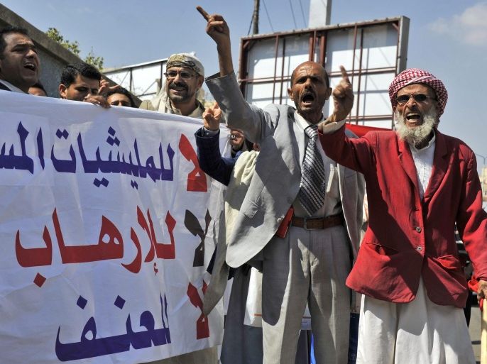 Yemeni activists hold a banner reading in Arabic: 'No to armed militias, No to terrorism, No to Violence' while shouting slogans during a rally against the control by Shiite Houthi fighters of the countrys main cities, in Sana'a, Yemen, 01 November 2014. Reports state Yemeni activists took to the streets in Sana'a to protest against armed militias of the Shiite Houthi movement, a day after at a pro-Houthi movement tribal gathering gave a 10-day deadline for Yemeni President Abdo Rabbo Mansour Hadi to form a new government.