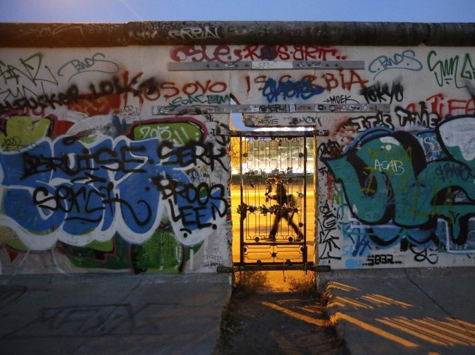 A door is seen at painted sections of the East Side Gallery, the largest remaining part of the former Berlin Wall, in Berlin, November 3, 2014. Germany will celebrate the 25th anniversary of the fall of the wall on November 9. REUTERS/Fabrizio Bensch (GERMANY - Tags: ANNIVERSARY SOCIETY POLITICS TPX IMAGES OF THE DAY)