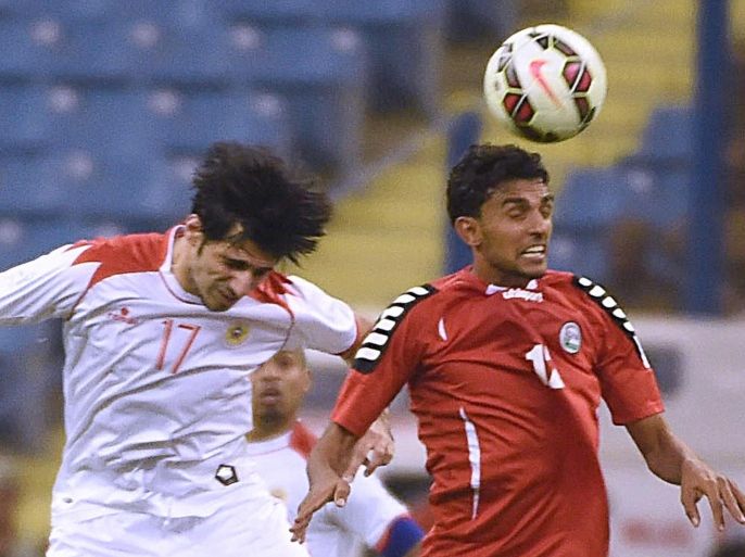Yemeni footballer Ahmed Al Hifi (R red) and Bahrain's Husain Ali Baba fight for the ball during during the 22nd Gulf Cup football match at King Fahad stadium in Riyadh on November 13, 2014. AFP PHOTO/ FAYEZ NURELDINE