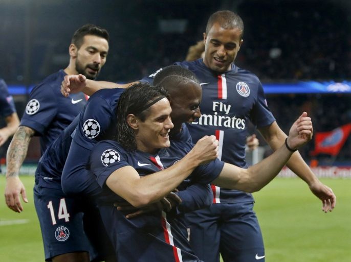 Paris St Germain's Edinson Cavani (bottom) reacts with teammates after scoring the first goal for his team during their Champions League soccer match against APOEL Nicosia at the Parc des Princes in Paris November 5, 2014. REUTERS/Charles Platiau (FRANCE - Tags: SPORT SOCCER)