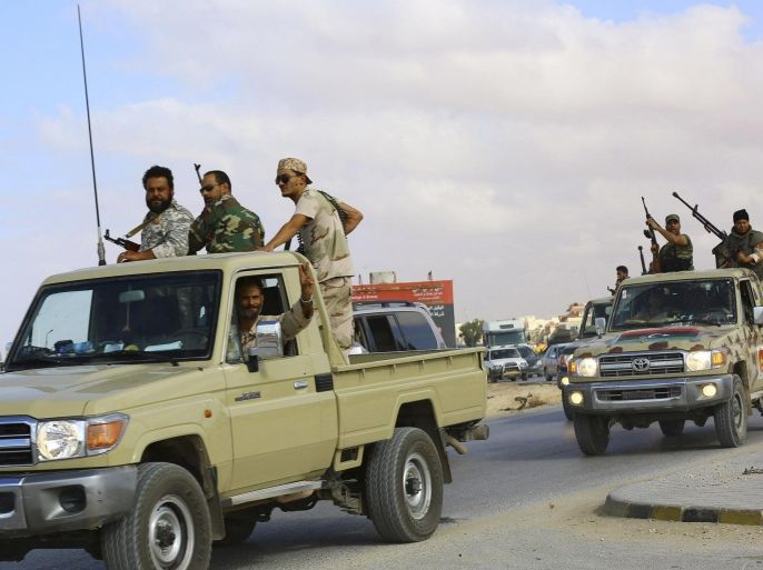 Forces loyal to former general Khalifa Haftar ride in vehicles in Benghazi November 20, 2014. Libya is in growing chaos as armed factions compete for power. One has taken over the capital Tripoli, setting up its own government and parliament and forcing the elected parliament and administration of Prime Minister Abdullah al-Thinni to move east. Picture taken November 20, 2014. REUTERS/Stringer (LIBYA - Tags: CIVIL UNREST POLITICS CONFLICT)