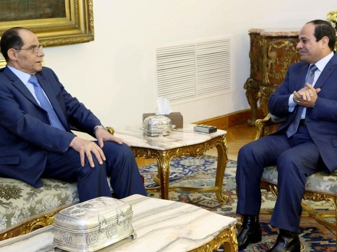 In this photo provided by Egypt's state news agency MENA, Egyptian President Abdel-Fattah el-Sissi, right, talks with intelligence chief Gen. Mohammed Farid el-Tohamy in Cairo, Egypt, Sunday, Dec. 21, 2014. El-Sissi awarded el-Tohamy the Republic Award, one of the state's highest awards, after ordering his retirement. (AP Photo/MENA, Mohammed Samaha)