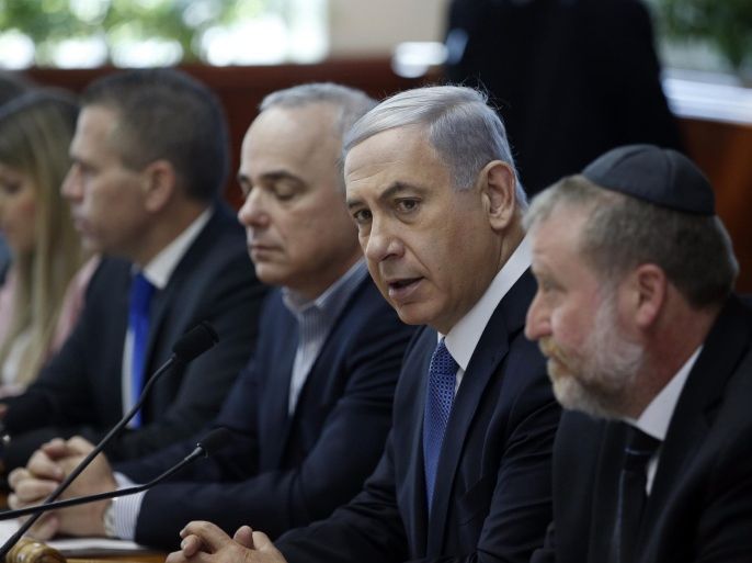 Israel's Prime Minister Benjamin Netanyahu, second left, chairs the weekly cabinet meeting in Jerusalem, Sunday, Nov. 30, 2014. Israel's prime minister said Sunday that the public expects the government to "return to normal conduct" and hinted at the possibility of early elections if his coalition does not overcome a crisis linked to a contentious nationality bill that would enshrine Israel's status as a Jewish state. The proposal would also make Jewish law a source of legislative inspiration and delist Arabic as an official language. (AP Photo/Ronen Zvulun, Pool)