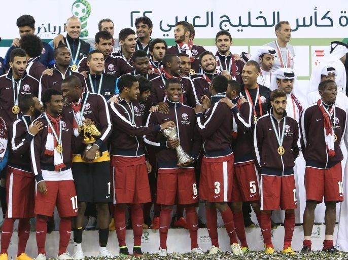 Qatar players pose with the Gulf Cup tropy after defeating Saudi Arabia 2-1 in the final of the 22nd Gulf Cup football match at the King Fahad stadium in Riyadh, on November 26, 2014. AFP PHOTO /KARIM JAAFAR / AL-WATAN DOHA ==QATAR OUT==