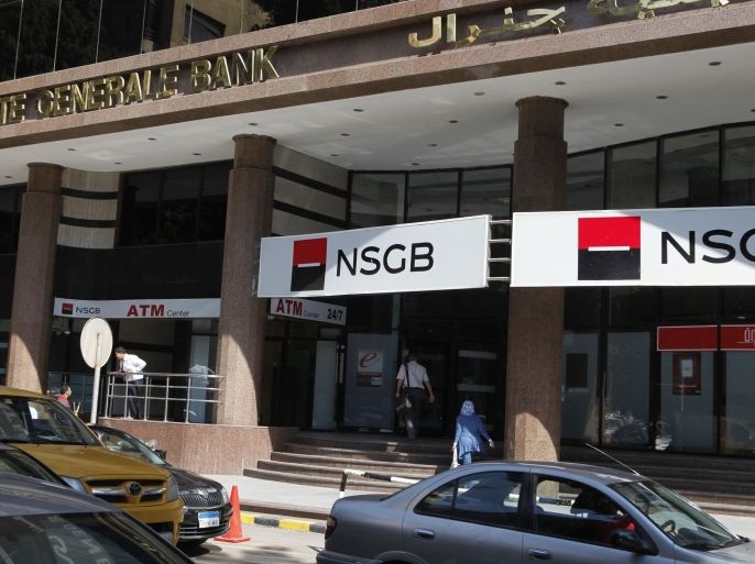 People enter a bank branch of National Societe Generale in central Cairo, September 3, 2012. The easiest pickings for Gulf investors in Egypt appear to be banking operations put up for sale by European lenders, which are retrenching globally. Flush with cash because of high oil prices, banks from the Gulf do not need to seek near-term profits in Egypt; they can take the long view, counting on Egypt's population growth to deliver profits down the road. Picture taken September 3, 2012. REUTERS/Asmaa Waguih (EGYPT - Tags: BUSINESS)