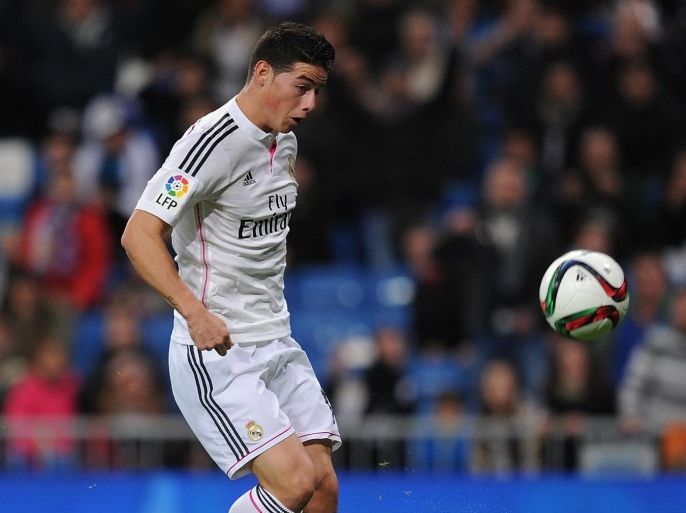 MADRID, SPAIN - DECEMBER 02: James Rodriguez scores Real's opening goal during the Copa Del Rey Round of 32, Second Leg match between Real Madrid CF and Cornella at Santiago Bernabeu stadium on December 2, 2014 in Madrid, Spain.