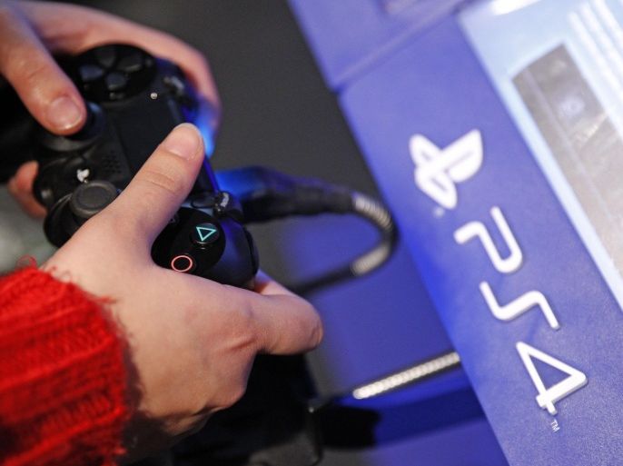 PARIS, FRANCE - DECEMBER 23: A visitor plays on Sony Playstation 4 video game console (PS4), produced by Sony Corp during the 'Noel de Geek' at the Cite des Sciences et de l'industrie on December 23, 2014 in Paris, France. 'Noel de Geek' takes place from December 23, 2014 till January 04, 2015.