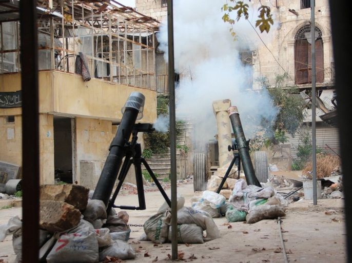 ALEPPO, SYRIA - DECEMBER 6: Islamic Front members attack the buildings, being used as headquarters by Asad regime forces, with bombs made of propane cylinder and called as 'hell' in the Old City of Aleppo, Syria on December 6,2014.