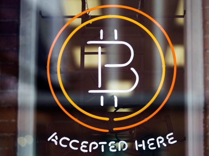 A Bitcoin sign is seen in a window in Toronto, in this file photo from May 8, 2014. After skyrocketing to more than a thousand dollars in price late last year and attracting worldwide attention, bitcoin, a digital currency, has lost momentum in its quest to become a widely-accepted payment method. REUTERS/Mark Blinch/Files (CANADA - Tags: BUSINESS LOGO)