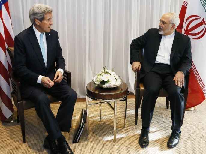Iranian Foreign Minister Mohammad Javad Zarif (R) talks on January 14, 2015 with US State Secretary John Kerry before their meeting in Geneva. Zarif said on January 14 that his meeting with his US counterpart was vital for progress on talks on Tehran's contested nuclear drive. Under an interim deal agreed in November 2013, Iran's stock of fissile material has been diluted from 20 percent enriched uranium to five percent, in exchange for limited sanctions relief. AFP PHOTO / POOL / RICK WILKING