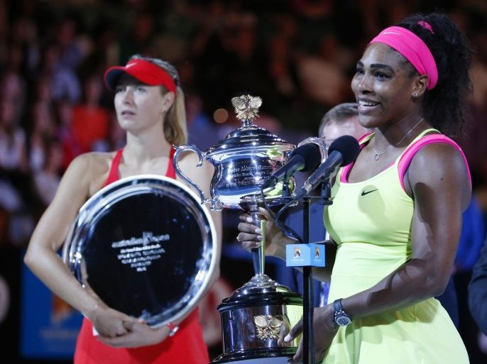 Serena Williams (R) of the US with the Daphne Akhurst Memorial Cup after winning against Maria Sharapova (L) of Russia in their women's finals match at the Australian Open Grand Slam tennis tournament in Melbourne, Australia, 31 January 2015.