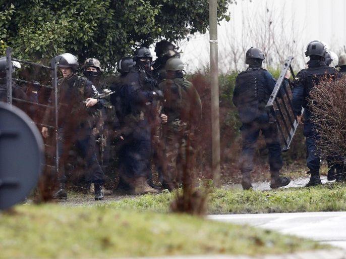 Police officers gather to prepare an assault in an industrial area where the suspects in the shooting attack at the satirical French magazine Charlie Hebdo headquarters are reportedly holding a hostage, in Dammartin-en-Goele, some 40 kilometres north-east of Paris, France, 09 January 2015. There has been an exchange of fire, according to media reports.