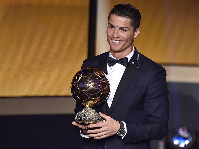 Real Madrid and Portugal forward Cristiano Ronaldo smiles after receiving the 2014 FIFA Ballon d'Or award for player of the year during the FIFA Ballon d'Or award ceremony at the Kongresshaus in Zurich on January 12, 2015. AFP PHOTO / FABRICE COFFRINI