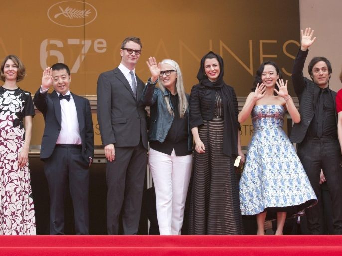 Jury members, from left, Willem Dafoe, Sophia Coppola, Jia Zhangke, Nicolas Winding Refn, Jury President Jane Campion, Leila Hatami, Jeon Do-yeon, Gael Garcia Bernal and Carole Bouquet wave from the top of the steps as they arrive for the screening of the Palme d'Or winner, Winter Sleep, during the closing night of the 67th international film festival, Cannes, southern France on Sunday, May 25, 2014. (AP Photo/Virginia Mayo)